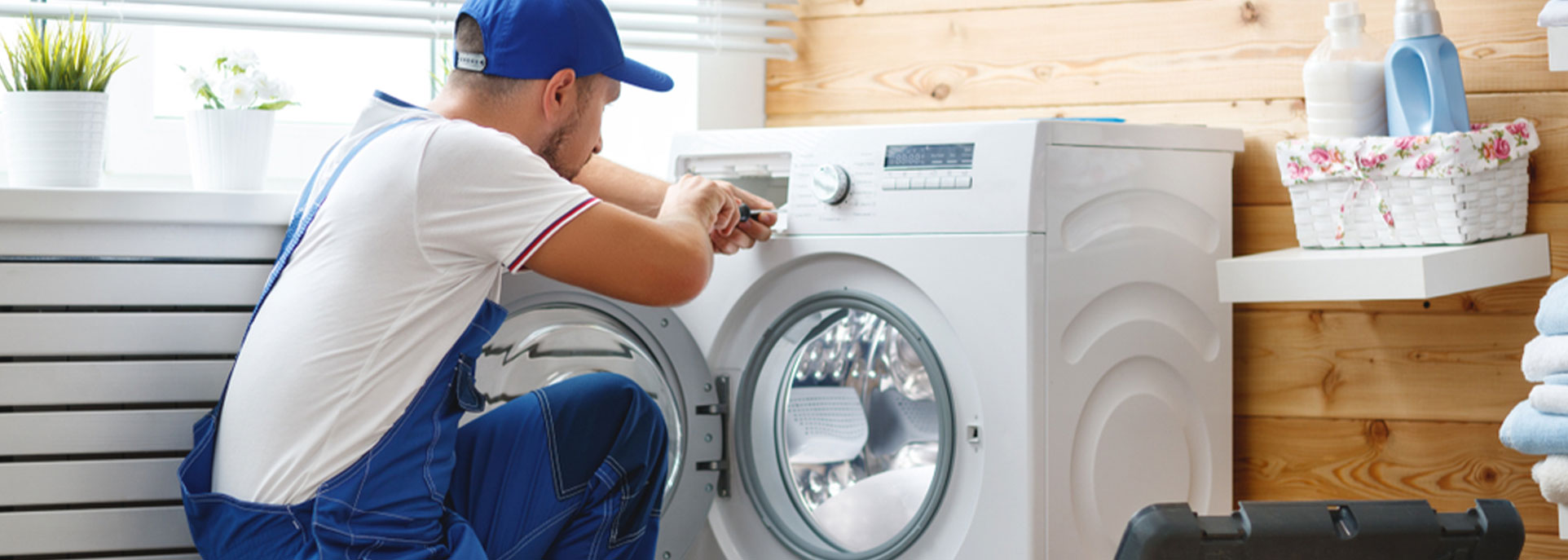Repair man working on washing machine