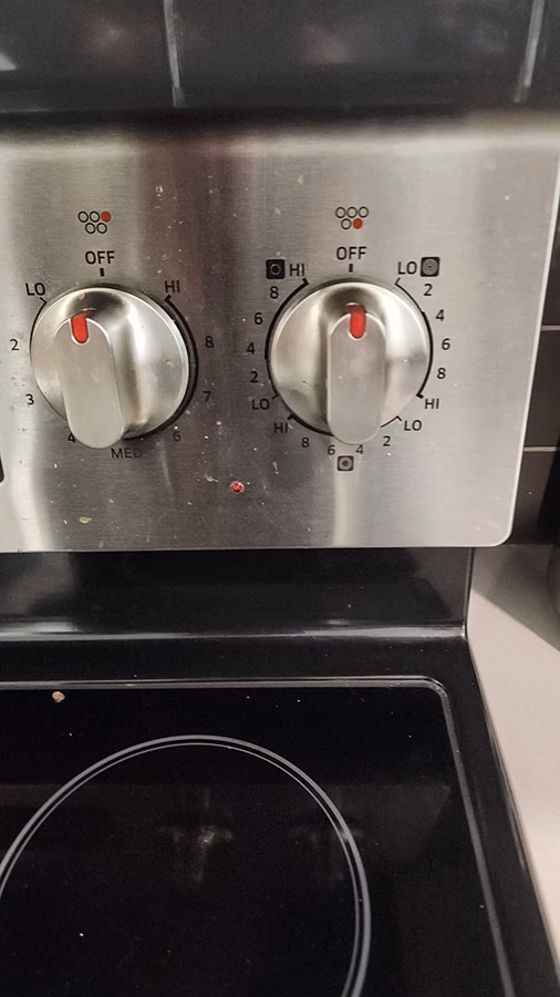 Wide close-up of the Samsung stove Fast Boil burner during post-repair testing. All heating rings are glowing evenly, confirming full burner function after the infinite switch was replaced.